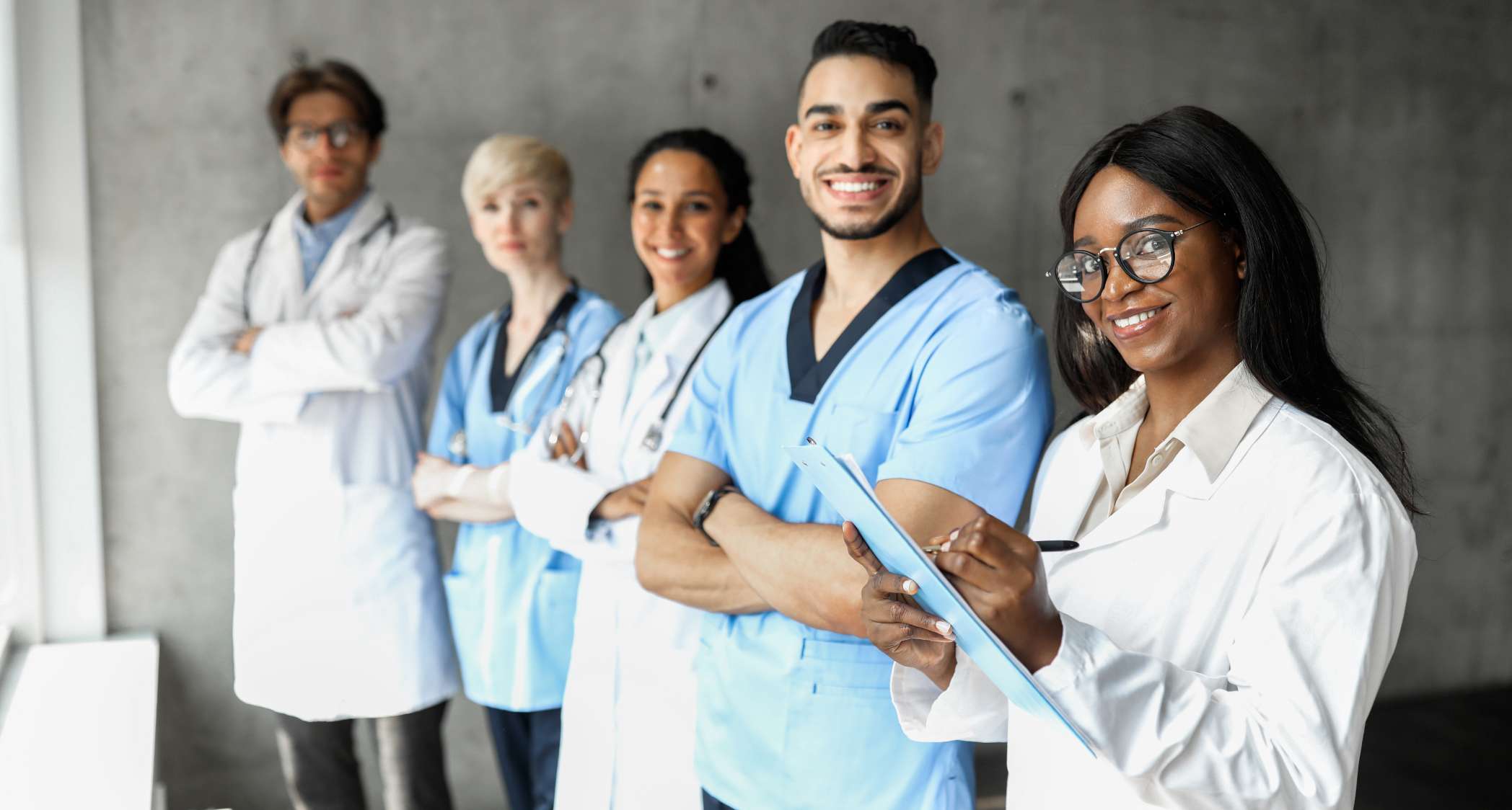 group of medical staff smiling and looking at the camera